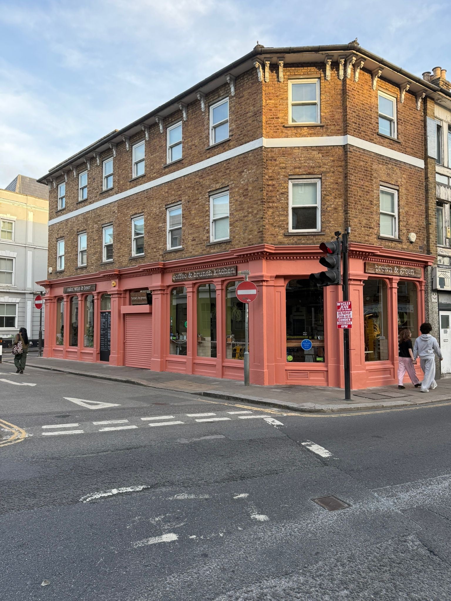 Restored corner cafe shopfront with fresh paint, sash windows above and the cafe trading on the ground floor